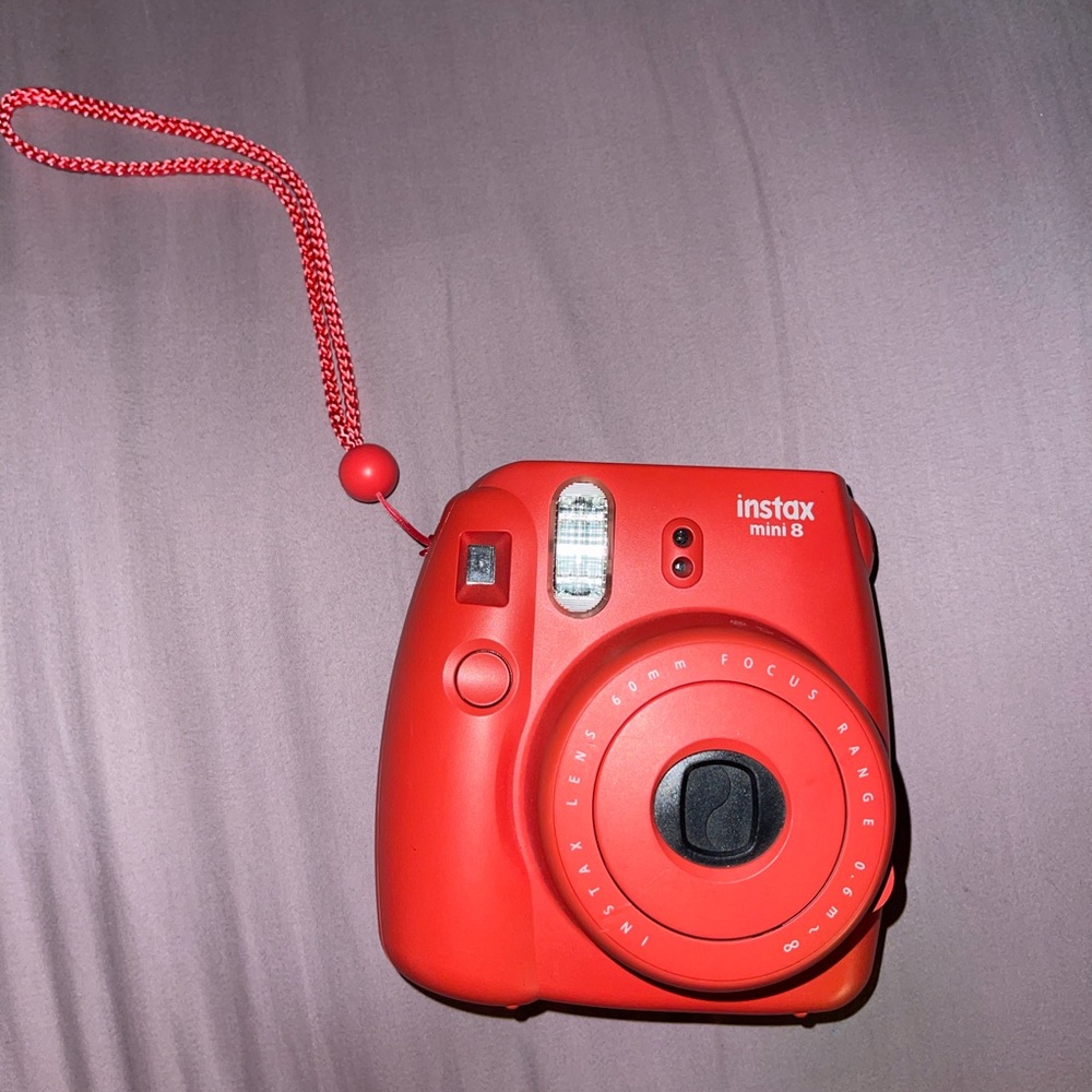 Red Fujifilm polaroid camera in perfect working condition
